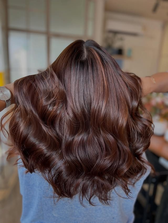 A warm chestnut colour with copper ribbons through it, in soft waves