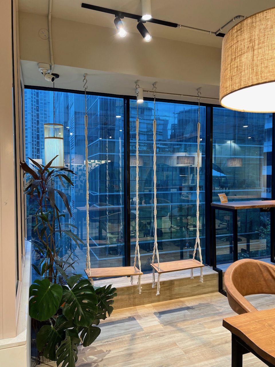 Macrame swings by the full-height windows